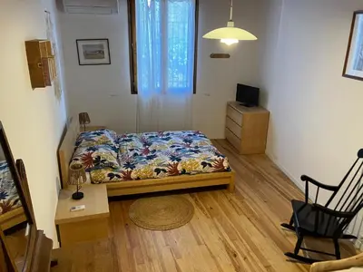 a room with a bed and a table and a chair at Chambres d'hôtes : Les maisons de Gaïa in Tuchan