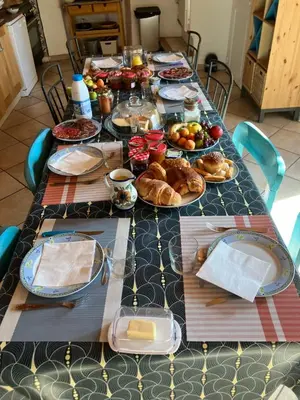 a long table with plates of food on it at Chambres d'hôtes : Les maisons de Gaïa in Tuchan