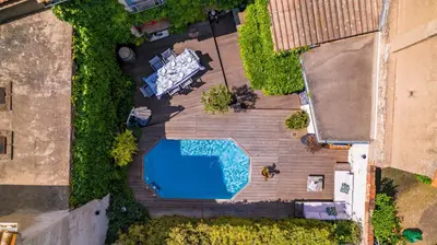 an overhead view of a swimming pool on a wooden deck at Maison de Vacances 8 à 15 pers à proximité du Canal du Midi in Sallèles-dʼAude
