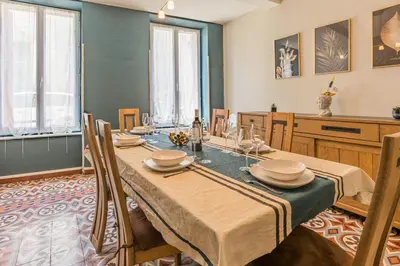 a dining room with a table and chairs at Maison de Vacances 8 à 15 pers à proximité du Canal du Midi in Sallèles-dʼAude