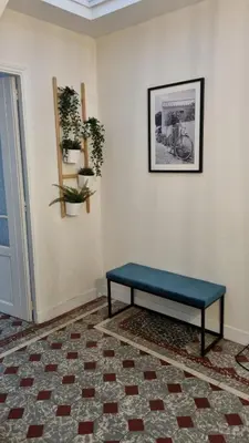 a blue bench sitting in a room at Maison de Vacances 8 à 15 pers à proximité du Canal du Midi in Sallèles-dʼAude