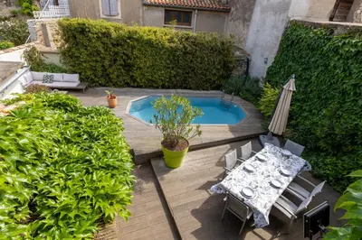 an overhead view of a patio with a table and an umbrella at Maison de Vacances 8 à 15 pers à proximité du Canal du Midi in Sallèles-dʼAude