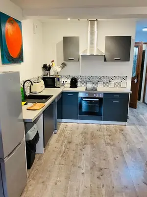 a kitchen with blue and white counters and appliances at Hôte Labyrinthe sur la place chambres d, hôtes , calme ,Netflix in Mirepoix