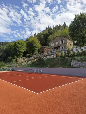 a tennis court with a tennis racket on it at La Gorge in Lacrouzette
