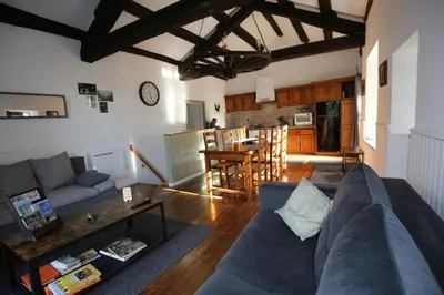 a living room with a couch and a table at La Gorge in Lacrouzette