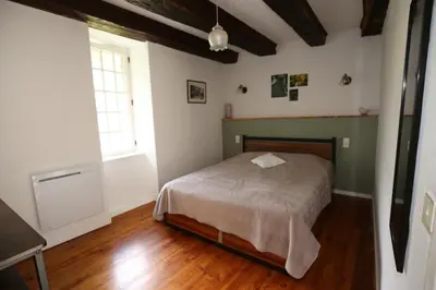 a bedroom with a bed and a window at La Gorge in Lacrouzette