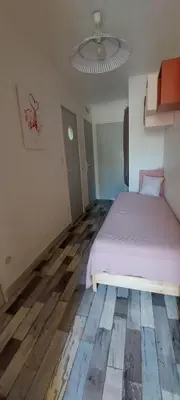 a bedroom with a bed and a wooden floor at Appartement RDC vue mer - GRUISSAN in Gruissan