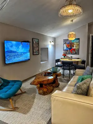 a living room with a couch and a table at Maison CABARET Luxury 4 Star Air Conditioned 100m to 4 Cathar Châteaux Lastours private Terrasse with views!! in Lastours