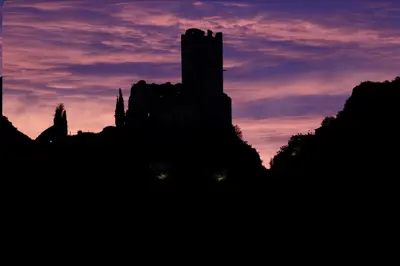 a silhouette of a castle against a sunset at Maison CABARET Luxury 4 Star Air Conditioned 100m to 4 Cathar Châteaux Lastours private Terrasse with views!! in Lastours