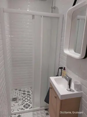 a bathroom with a shower and a white sink at Studio avec accès direct sur le port de Gruissan in Gruissan