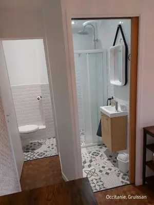 a bathroom with a toilet and a sink and a mirror at Studio avec accès direct sur le port de Gruissan in Gruissan