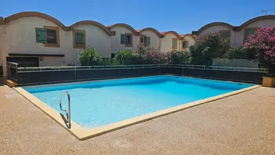 a large swimming pool in front of a building at Studio avec accès direct sur le port de Gruissan in Gruissan