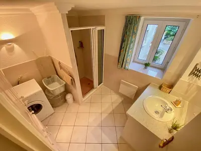a small bathroom with a sink and a shower at Centre of Olonzac, 2 bedrooms & private sunny rooftop terrace in Olonzac