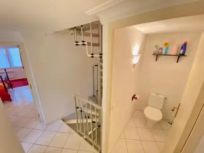 a bathroom with a toilet and a staircase at Centre of Olonzac, 2 bedrooms & private sunny rooftop terrace in Olonzac