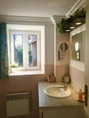 a bathroom with a sink and a window at Centre of Olonzac, 2 bedrooms & private sunny rooftop terrace in Olonzac