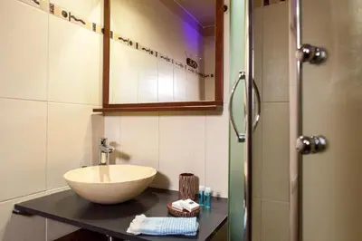 a bathroom with a sink and a shower at Péniche Mirage-chambre d'hôtes in Carcassonne
