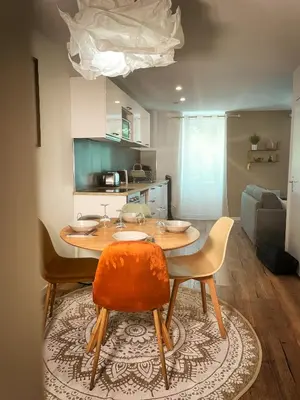 a kitchen with a table with chairs and a couch at Au cœur de Castres, logement cosy classé 3*** in Castres