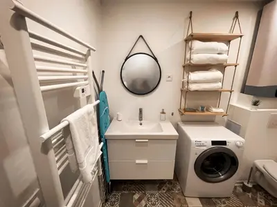 a bathroom with a washing machine and a sink at Au cœur de Castres, logement cosy classé 3*** in Castres