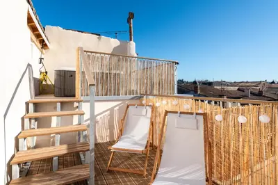 a balcony with two chairs and a ladder at Le 11 JACUZZI avec Terrasses Clim Netflix Parking in Carcassonne