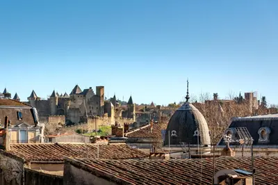 a view of a city with a castle in the background at Le 11 JACUZZI avec Terrasses Clim Netflix Parking in Carcassonne
