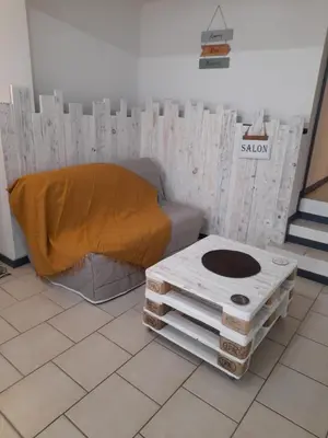a room with a bed and a couch and a table at Chez Sabine et Patrick in Narbonne