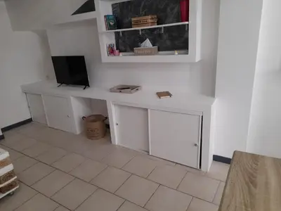 a room with a white desk with a tv on it at Chez Sabine et Patrick in Narbonne