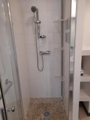 a bathroom with a shower with a glass door at Chez Sabine et Patrick in Narbonne