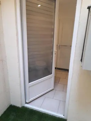 a sliding glass door to a shower in a bathroom at Chez Sabine et Patrick in Narbonne