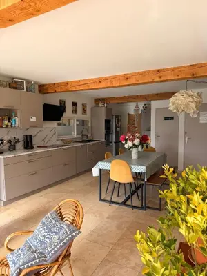a kitchen and dining room with a table and chairs at Maison 6 places, en plein cœur de l’Ariège, proche ski et nature in Lesparrou