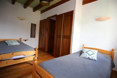 a bedroom with two twin beds and a closet at La Vallée in Lacrouzette