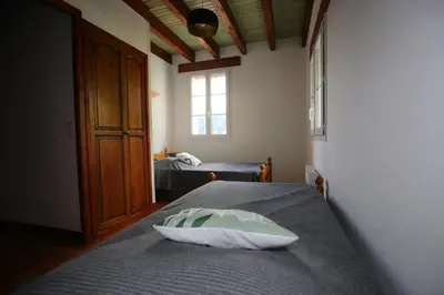 a bedroom with a bed and a window at La Vallée in Lacrouzette