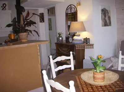 a kitchen and dining room with a table and chairs at Un havre de paix in Aigues-Vives