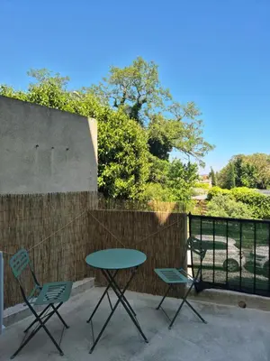 a table and two chairs on a patio at Le Jungle Appart, centre ville Narbonne in Narbonne