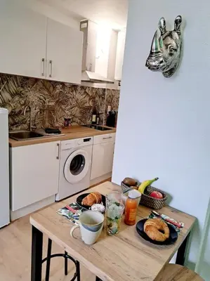 a kitchen with a table with food on it at Le Jungle Appart, centre ville Narbonne in Narbonne