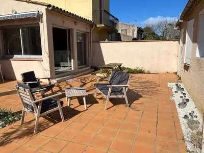 two chairs and a table on a patio at Maison la Soleiade in Carcassonne