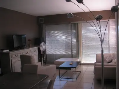 a living room with a couch and a table at Maison la Soleiade in Carcassonne