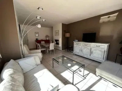 a living room with a couch and a table at Maison la Soleiade in Carcassonne