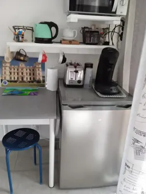 a small kitchen with a table and a counter top at Casa Vignes & Soleil in Puisserguier