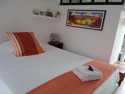 a bedroom with a large white bed with avisor at Casa Vignes & Soleil in Puisserguier