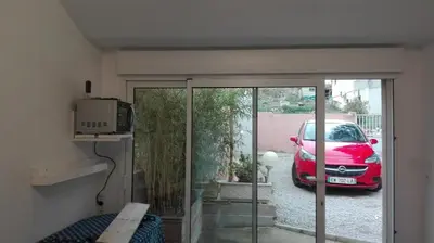 a red car is parked in a parking lot at Casa Vignes & Soleil in Puisserguier