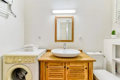 a bathroom with a sink and a washing machine at Le Jacques - Proche centre - RDC - Netflix in Carcassonne