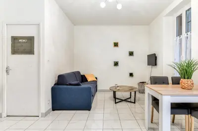 a living room with a blue couch and a table at Le Jacques - Proche centre - RDC - Netflix in Carcassonne