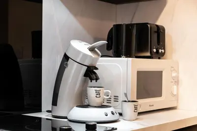 a coffee maker sitting on a counter next to a microwave at Le Jacques - Proche centre - RDC - Netflix in Carcassonne