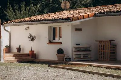 a small white house with a window and some plants at Gîtes Chaleureux écoresponsable in Montesquieu-Lauragais