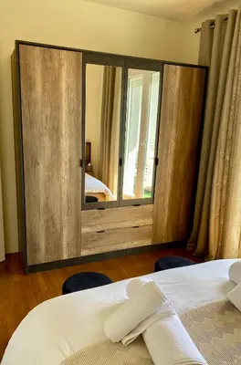 a bedroom with a large mirror and a bed at Maison face à la cité in Carcassonne