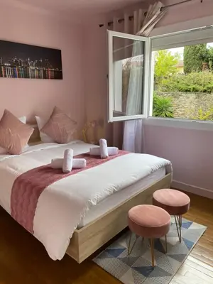 a bedroom with a large bed with a window at Maison face à la cité in Carcassonne