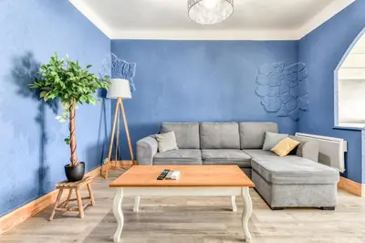a living room with a couch and a table at L'Arche de la Cité - Netflix - Disney - Clim in Carcassonne