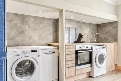 a laundry room with a washer and dryer at L'Arche de la Cité - Netflix - Disney - Clim in Carcassonne