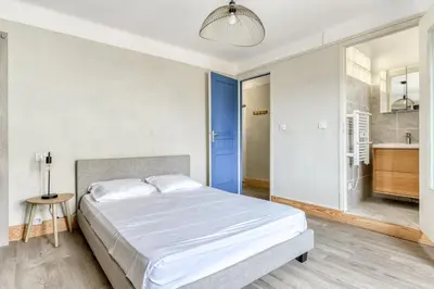 a bedroom with a large bed and a bathroom at L'Arche de la Cité - Netflix - Disney - Clim in Carcassonne