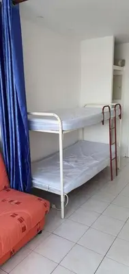 a room with a white shelf and a bed at Gruissan studio aux Amarines au bord de la plage du Grazel in Gruissan